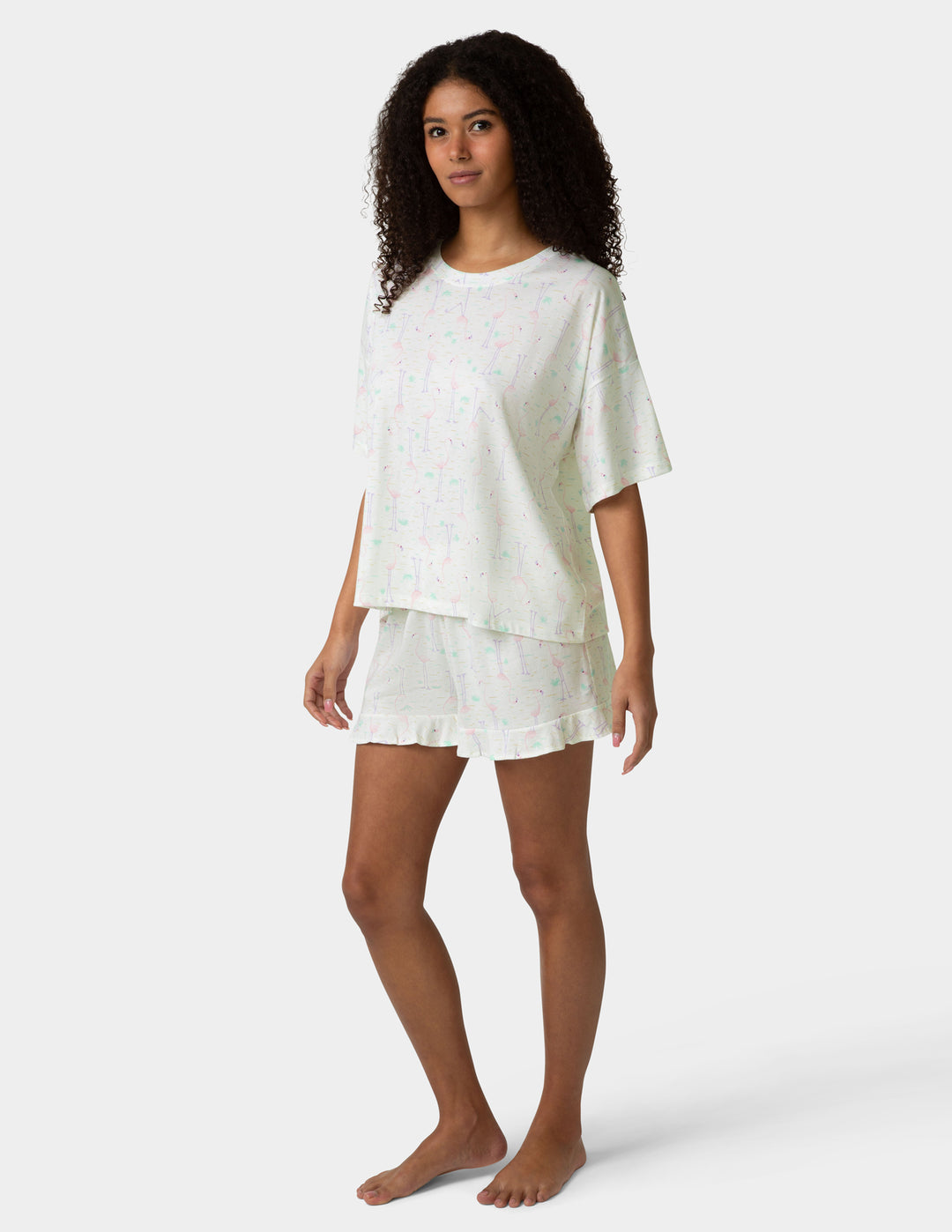Woman wearing a white pajama set on a white background