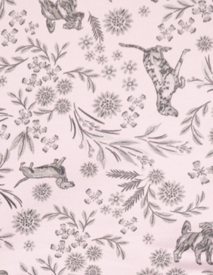 A light pink fabric featuring floral print and dogs all over.