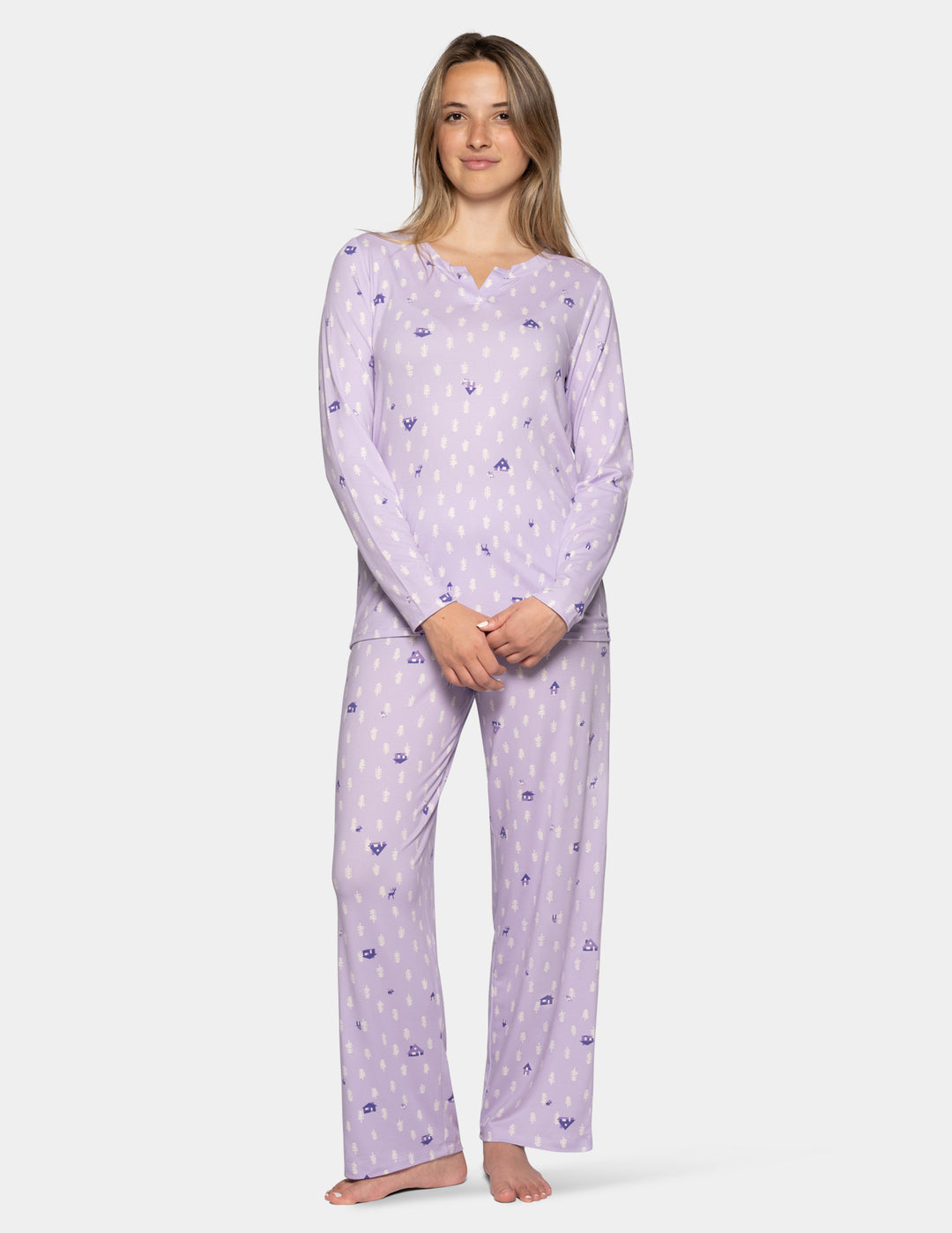 A model wearing a lilac matching pajama set featuring long sleeves and full length pants against a light gray background.