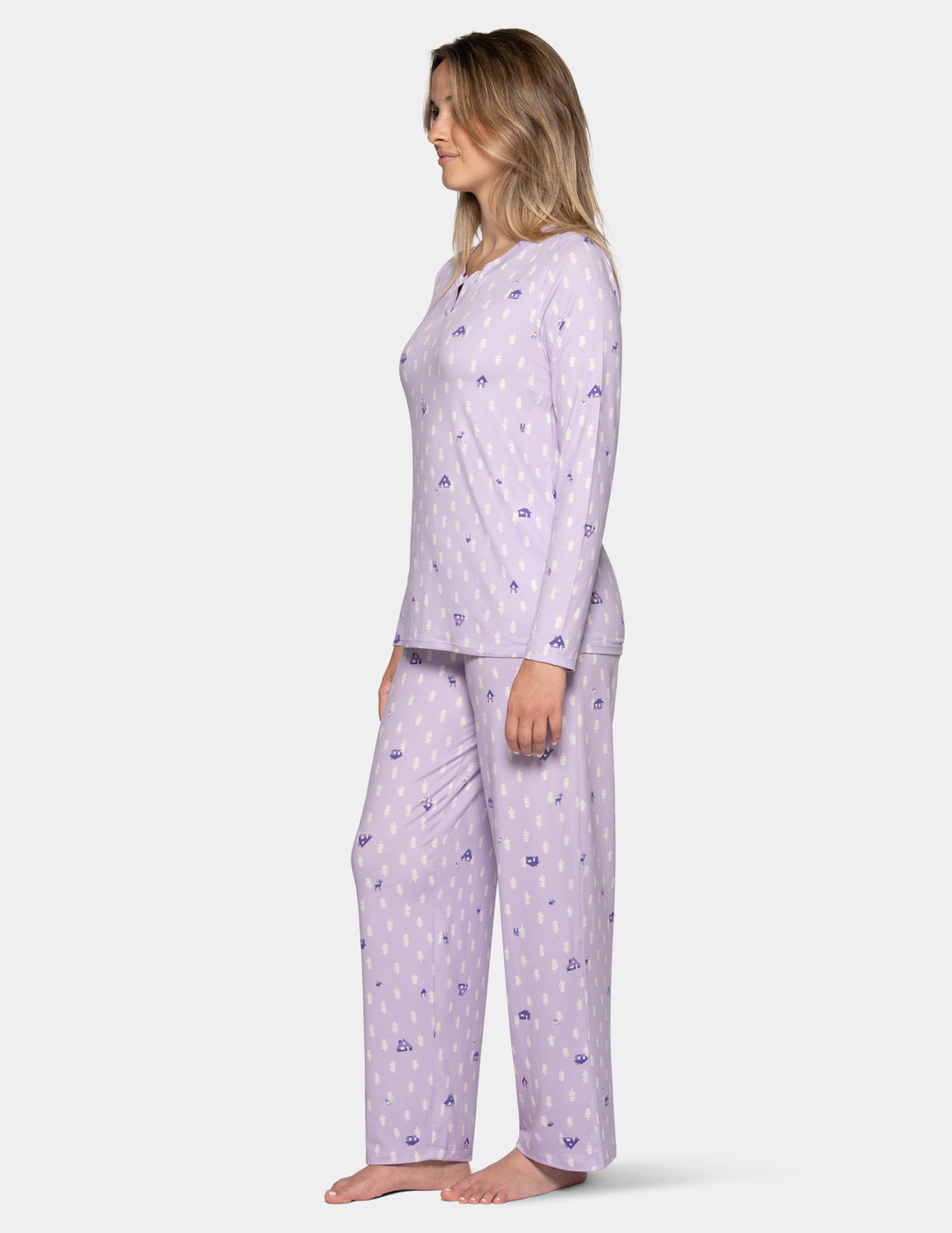 A woman modeling a light purple long-sleeve pajama set with a small repeating pattern, shown in profile against a plain light gray studio background.