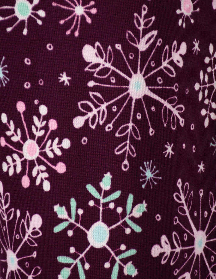 A close-up of a purple background fabric with a snowflake design.