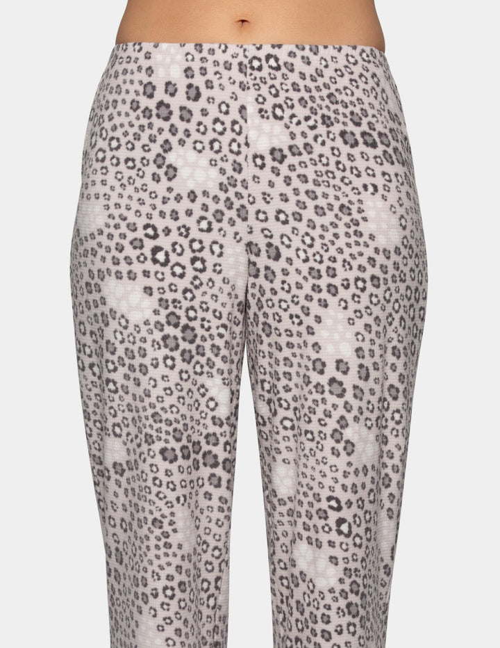 Woman wearing leopard print pajama pants.