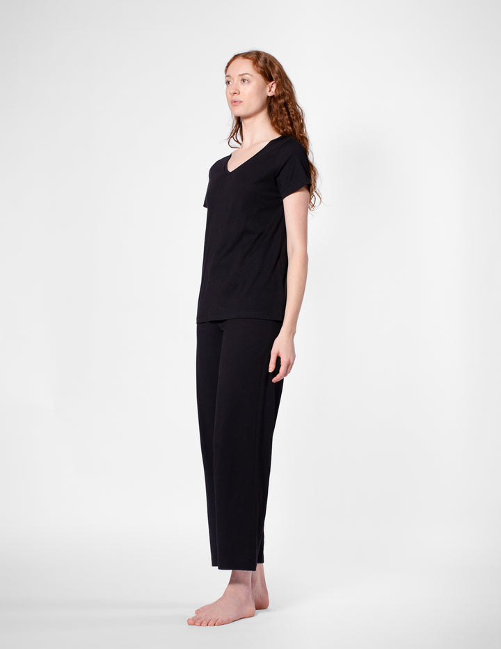 Woman wearing a black outfit on a white background