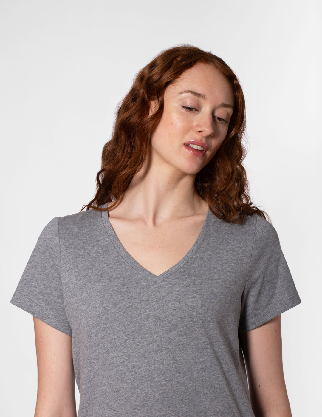 Woman wearing a gray t-shirt against a white background