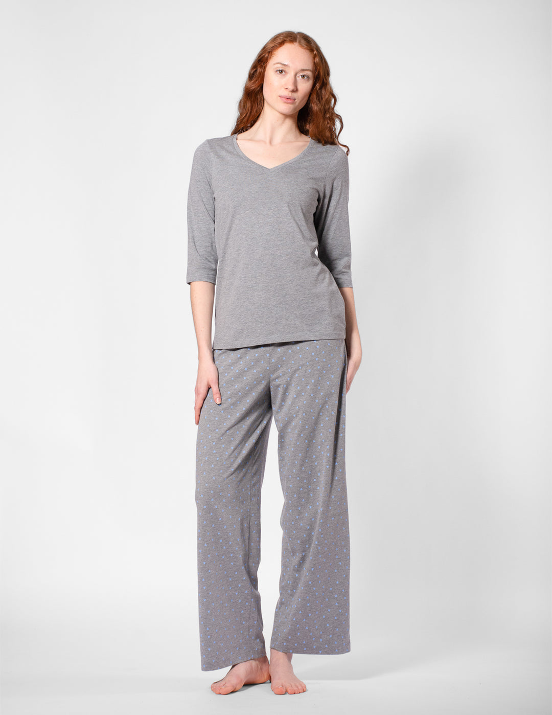 Woman wearing gray pajamas on a white background