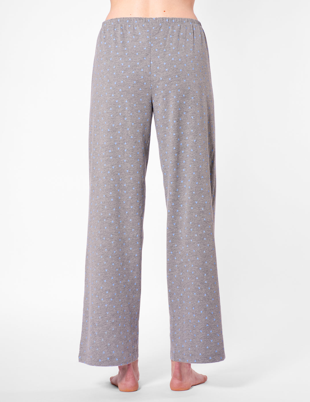 Gray patterned pajama pants worn by a person on a white background