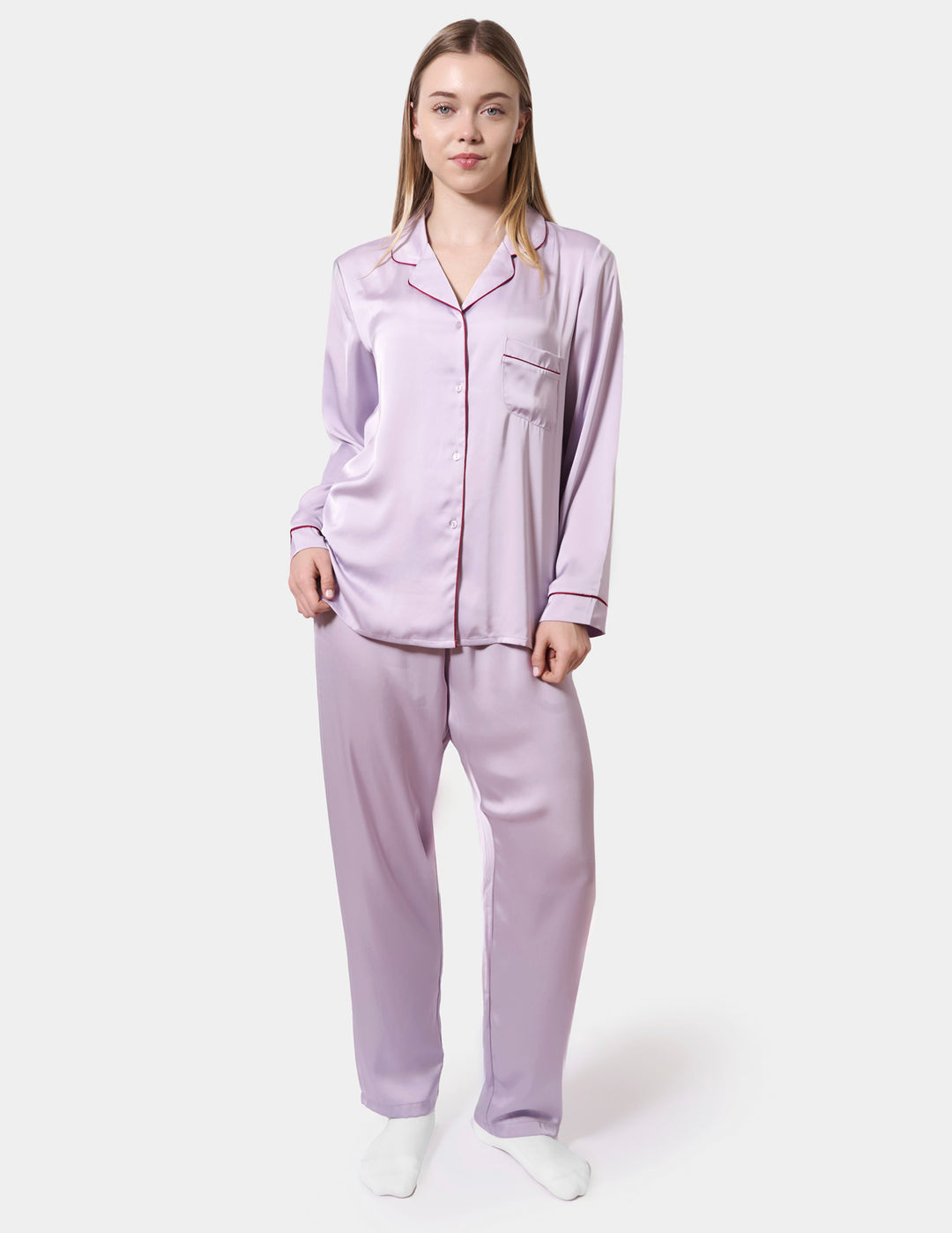 Woman wearing a light purple pajama set on a white background