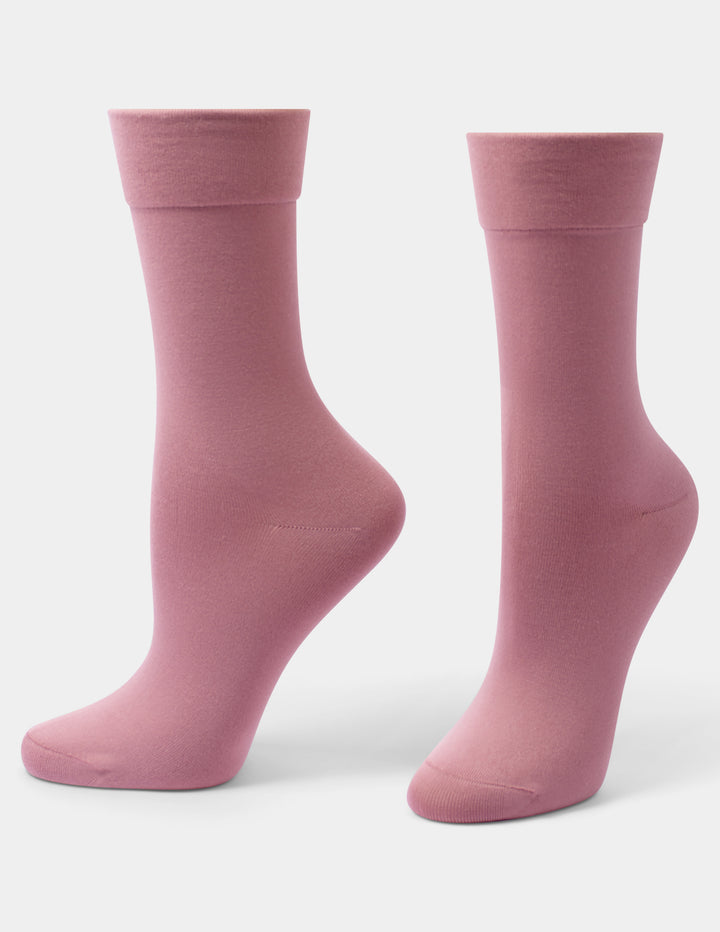 A pair of dusty pink crew socks shown from the side against a light gray background.