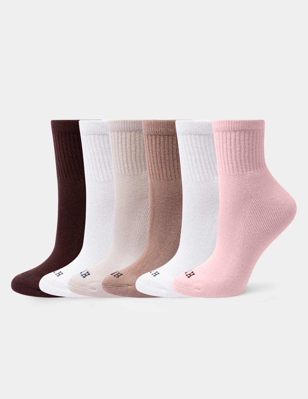 A set of six mini crew socks in various neutral shades, including dusty pink, white, tan, beige, and dark brown, arranged against a light gray background.