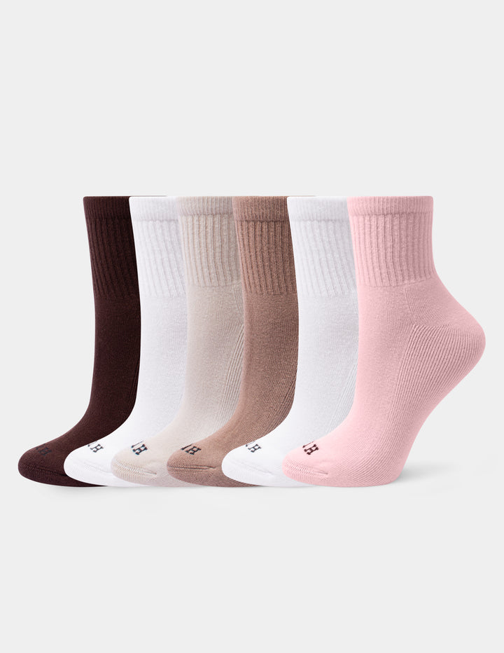 A set of six mini crew socks in various neutral shades, including dusty pink, white, tan, beige, and dark brown, arranged against a light gray background.