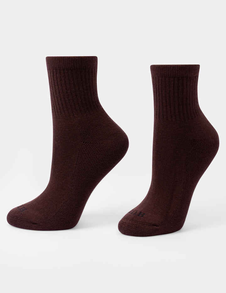 A pair of dark brown crew mini socks with a small HUE logo on the toes, displayed against a light gray background.