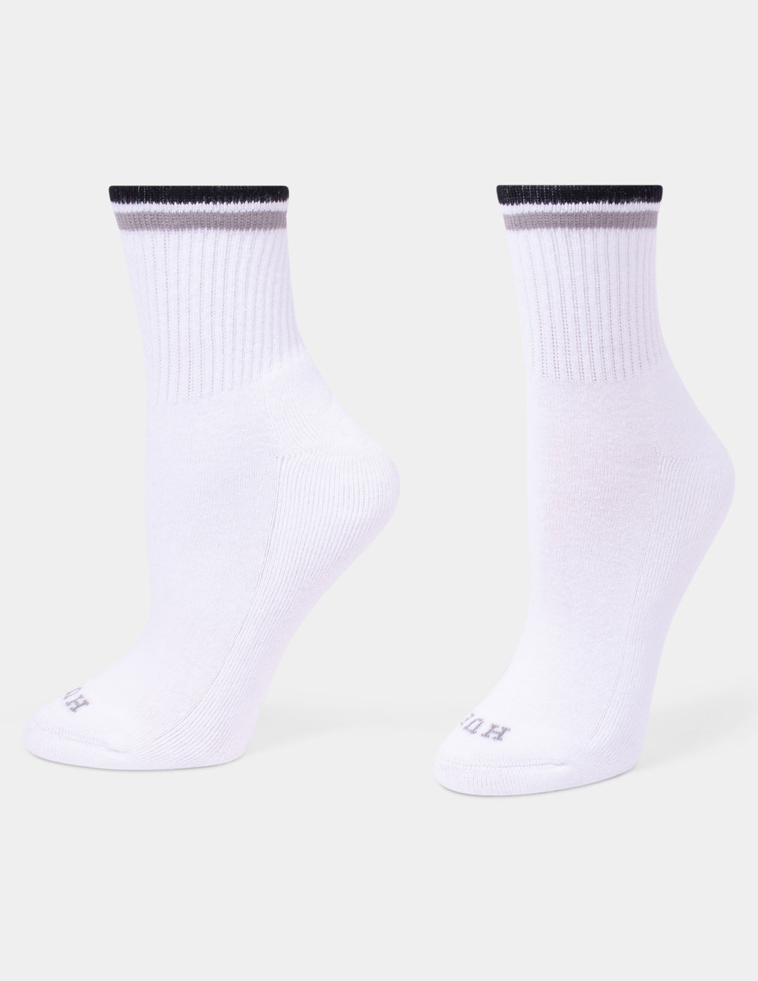 A pair of white crew socks with a black and gray ribbed cuff, shown against a light gray background.