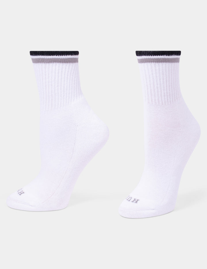 A pair of white crew socks with a black and gray ribbed cuff, shown against a light gray background.