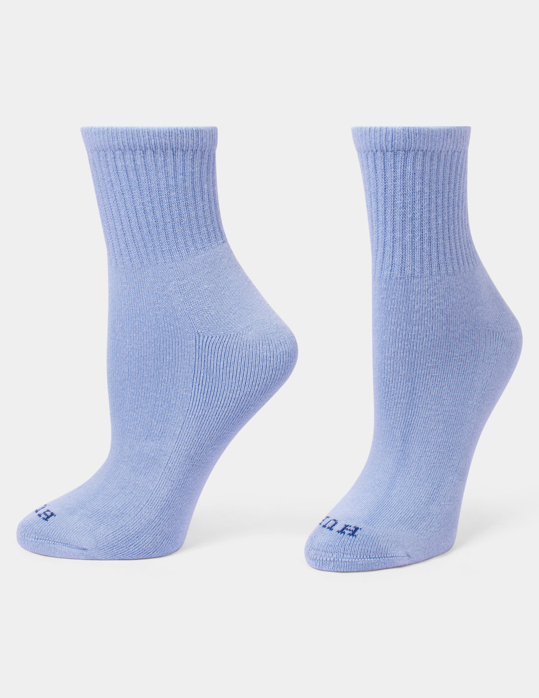 A pair of light blue mini crew socks displayed on foot forms against a light gray background.