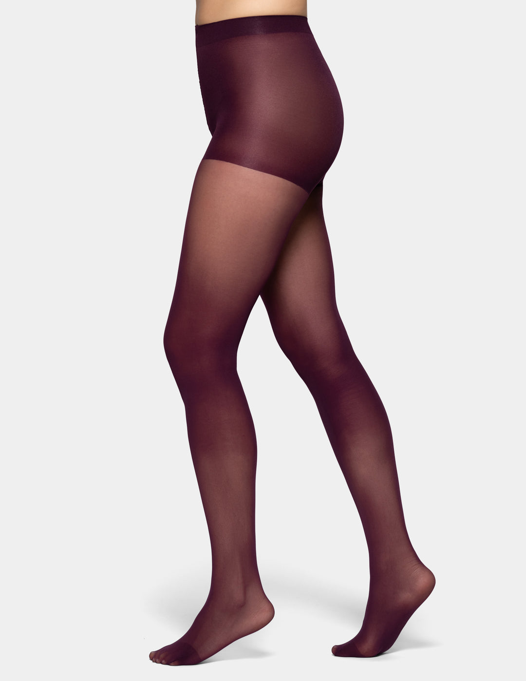 A model's legs wearing sheer dark plum tights against a light gray background.