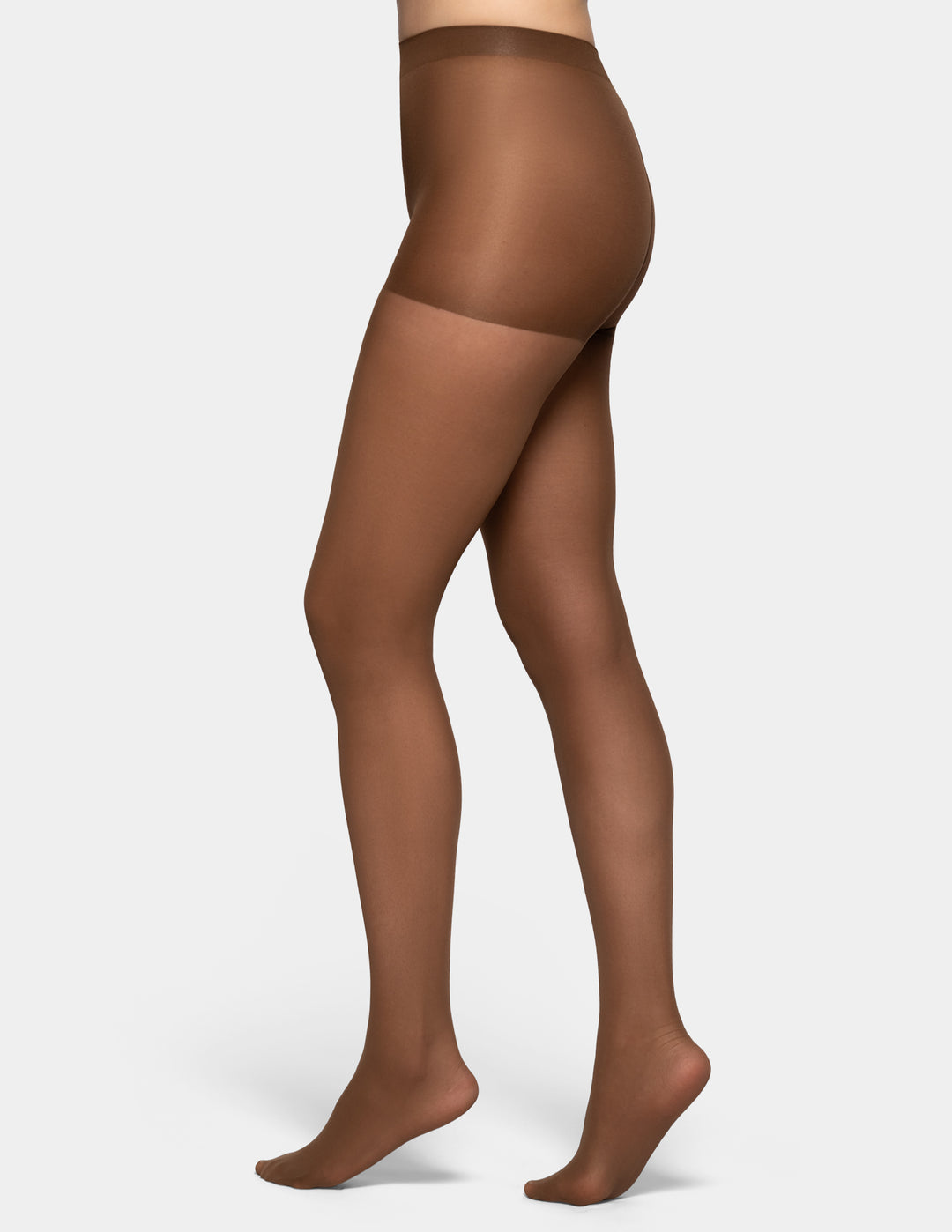 A model's lower body wearing sheer brown tights against a light gray background.