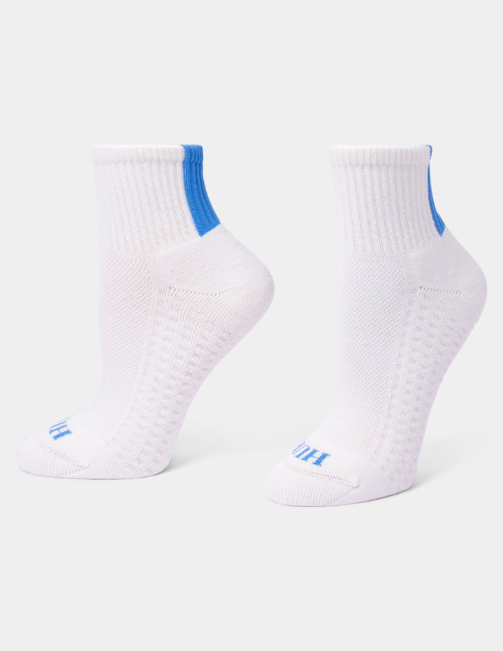 A pair of white athletic crew socks with bright blue accents on the heel and toe, displayed against a clean white background.