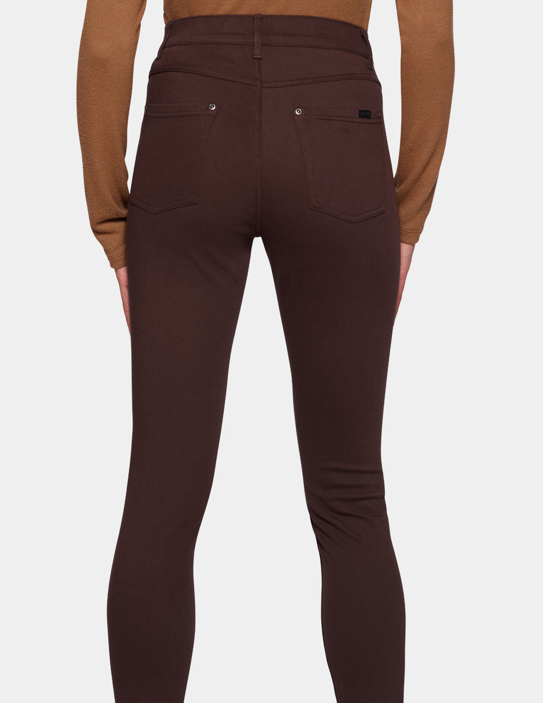 Rear view of a model wearing dark brown high-waisted leggings