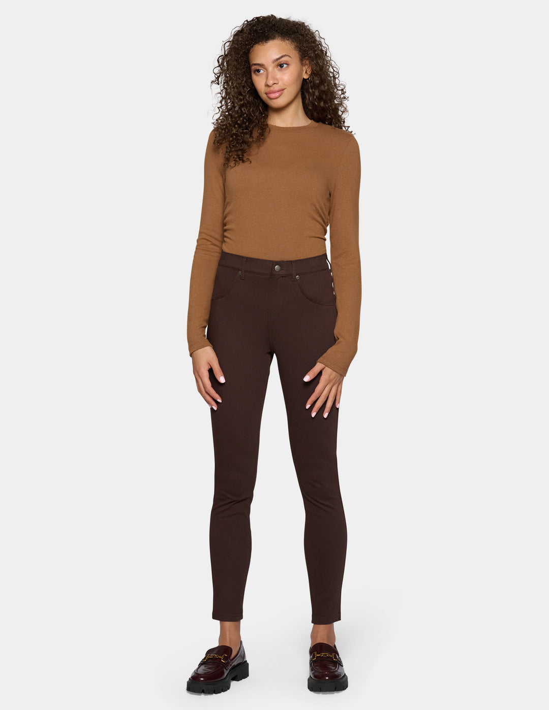 A woman modeling dark brown leggings