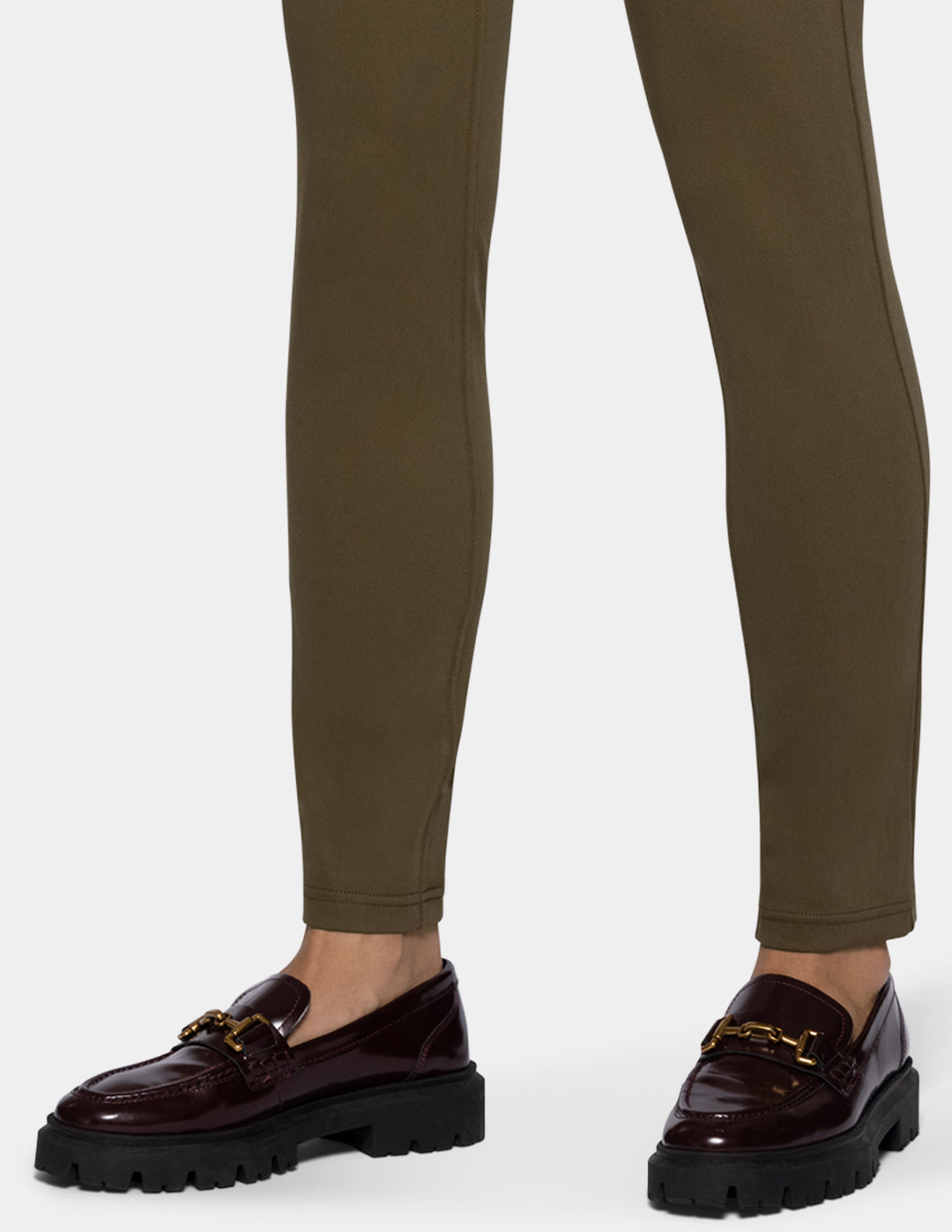 A person wearing olive green leggings 
