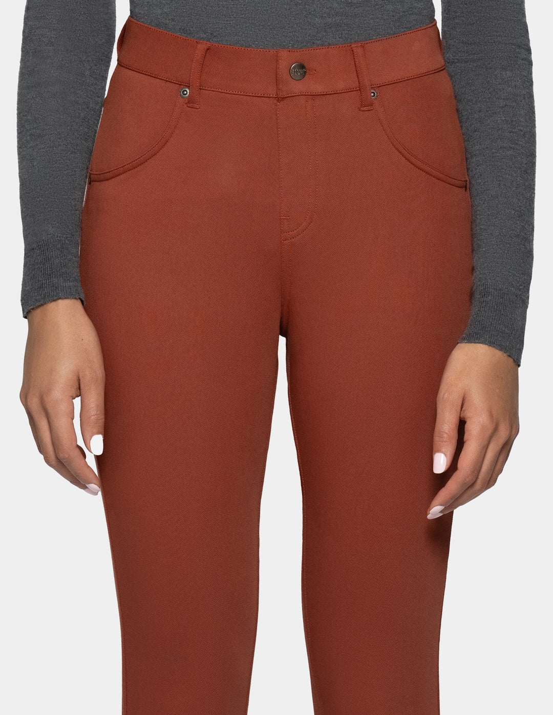 A person wearing rust-colored slim-fit leggings 