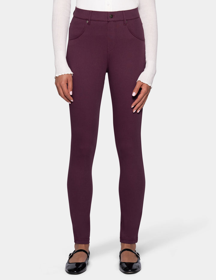 A model wearing a pair of dark plum leggings