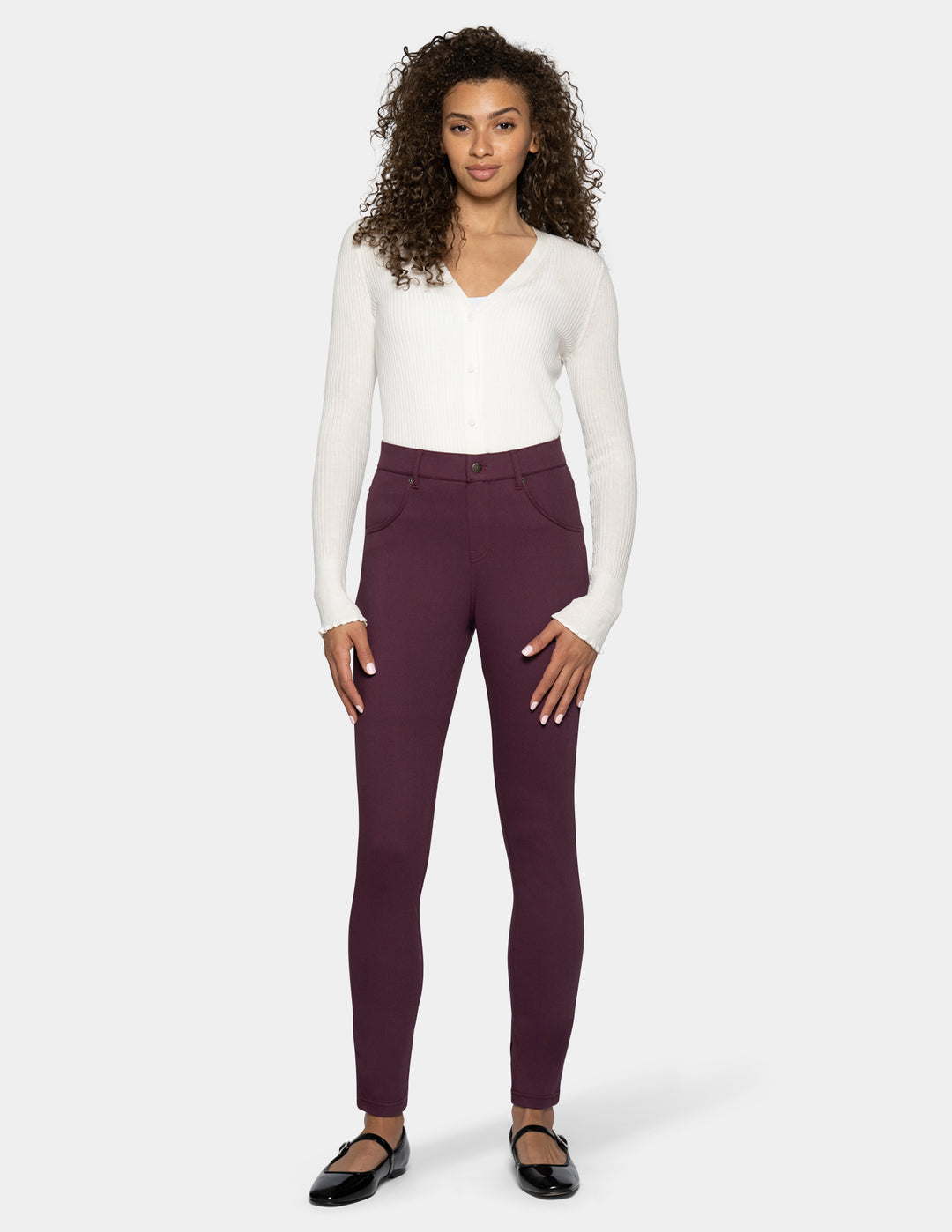A woman modeling a pair of high-waisted leggings