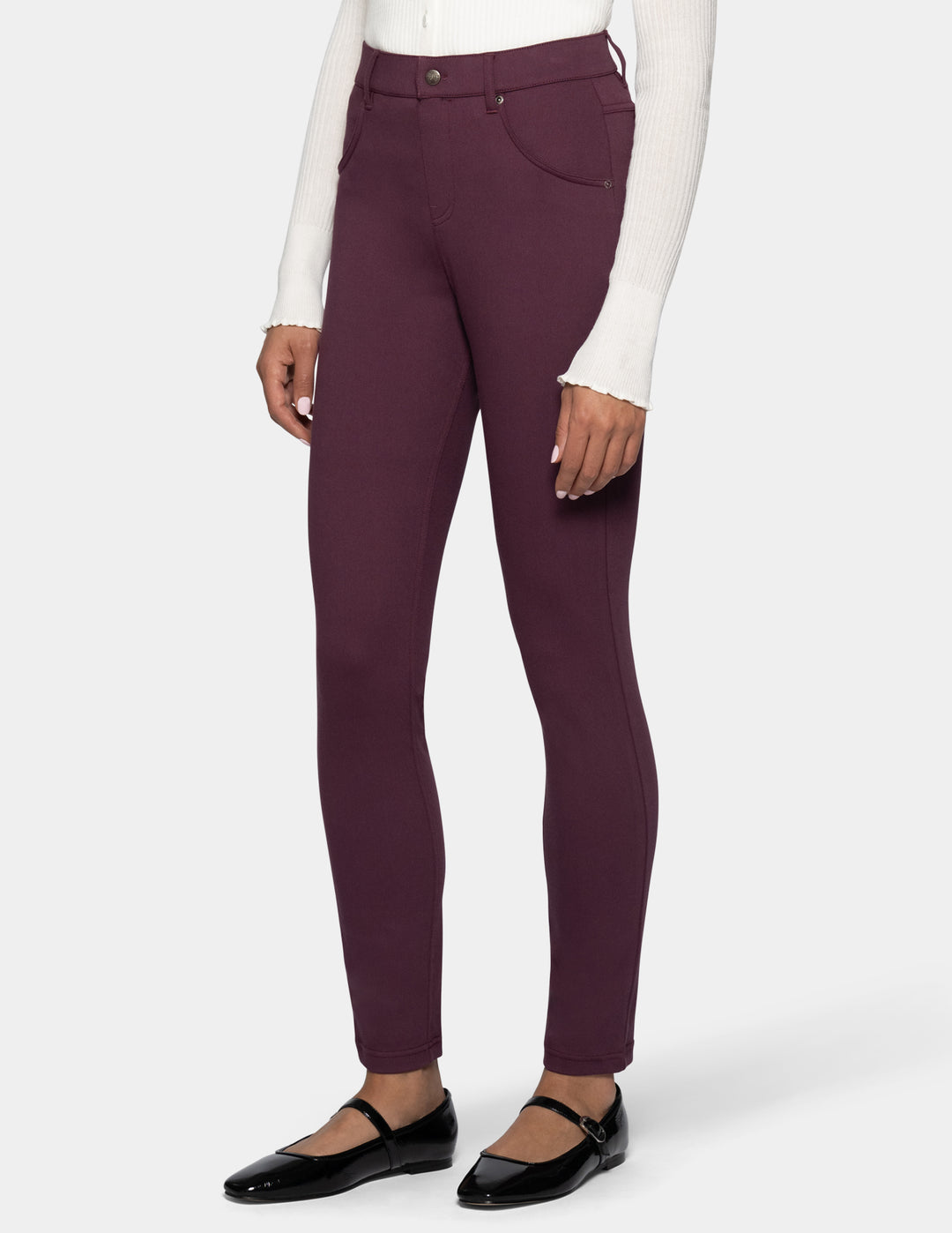 A model wearing a pair of high-waisted burgundy leggings