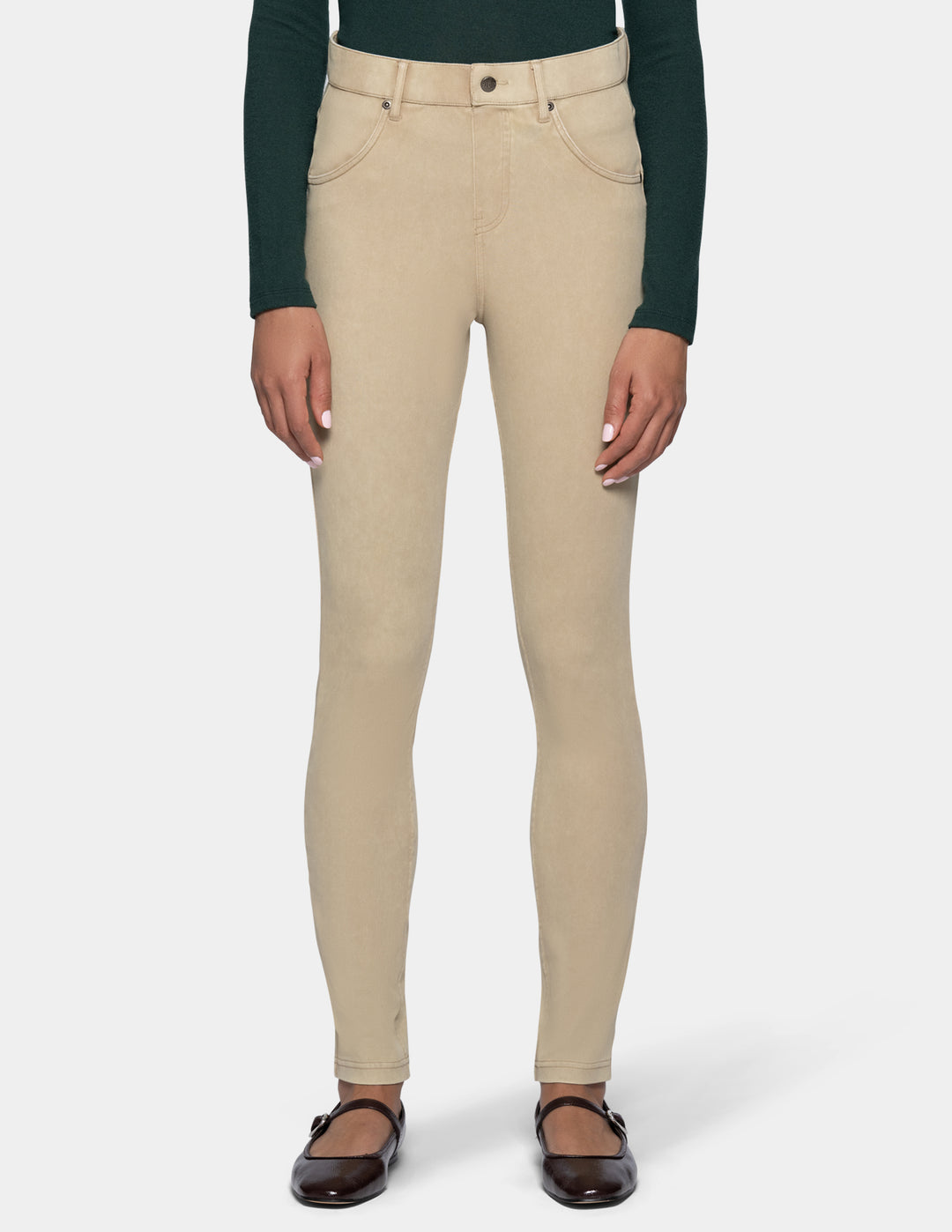 A model from the waist down wearing beige leggings