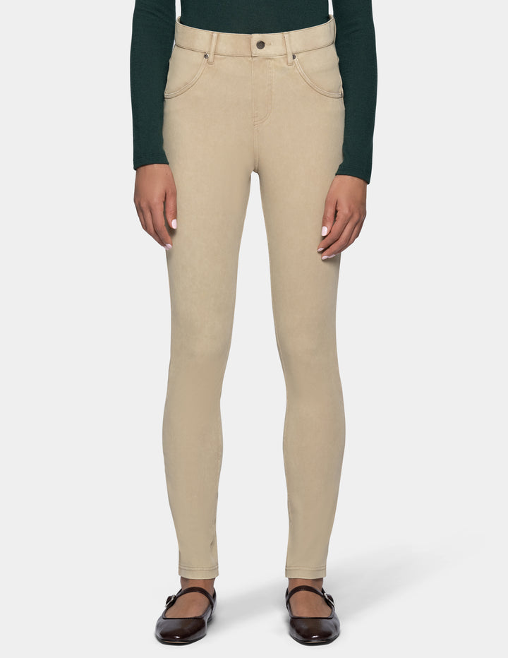 A model from the waist down wearing beige leggings