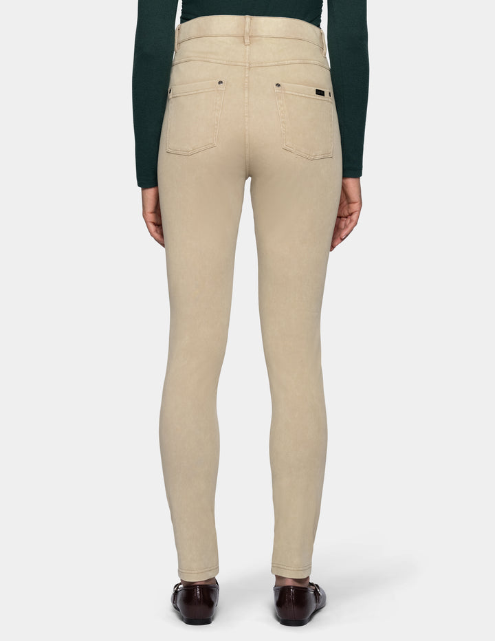 A person shown from the back wearing beige leggings
