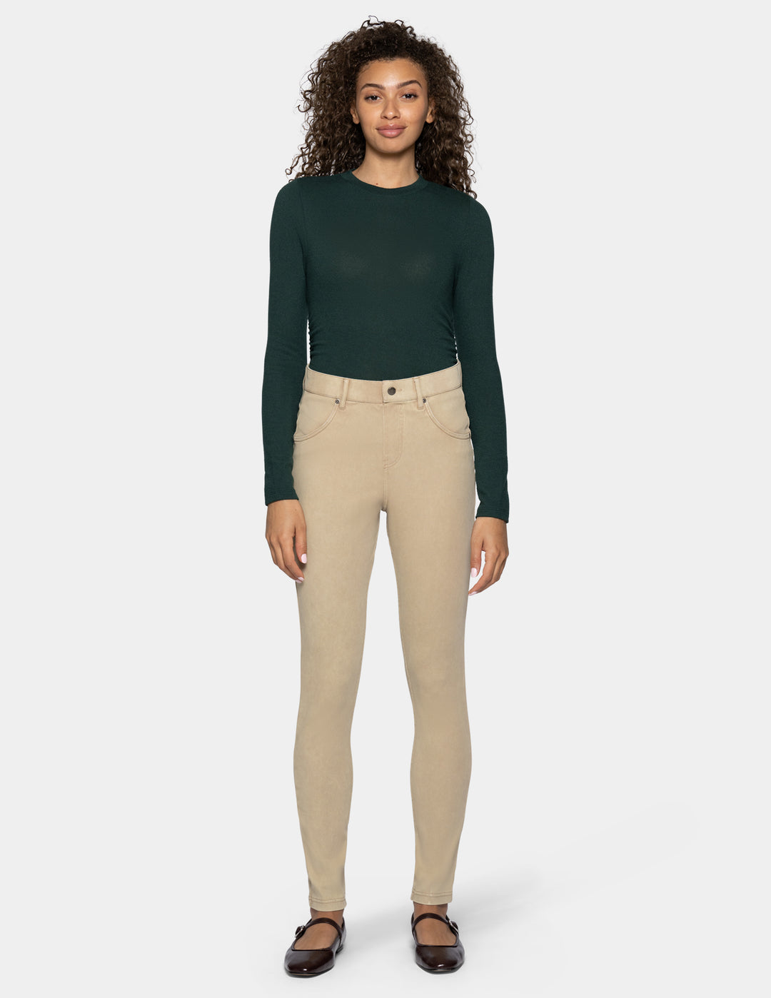 A woman modeling beige skinny leggings