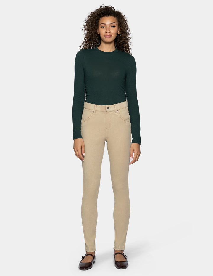 A woman modeling beige skinny leggings