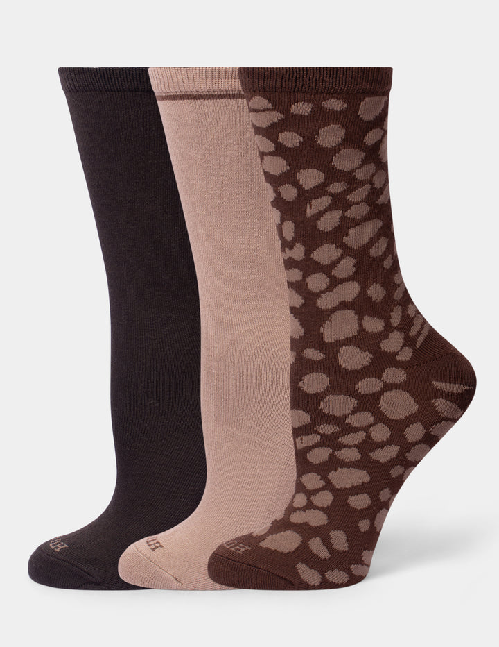 Three neutral color crew socks on a light gray background. 