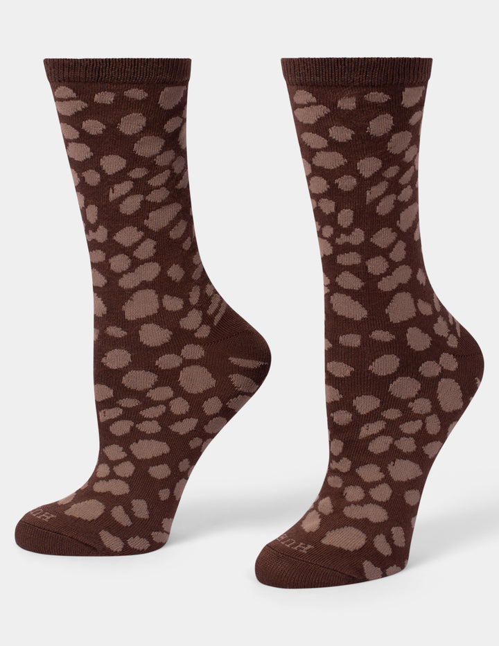 A pair of dark brown crew socks with a lighter brown leopard print pattern, displayed against a light gray background.