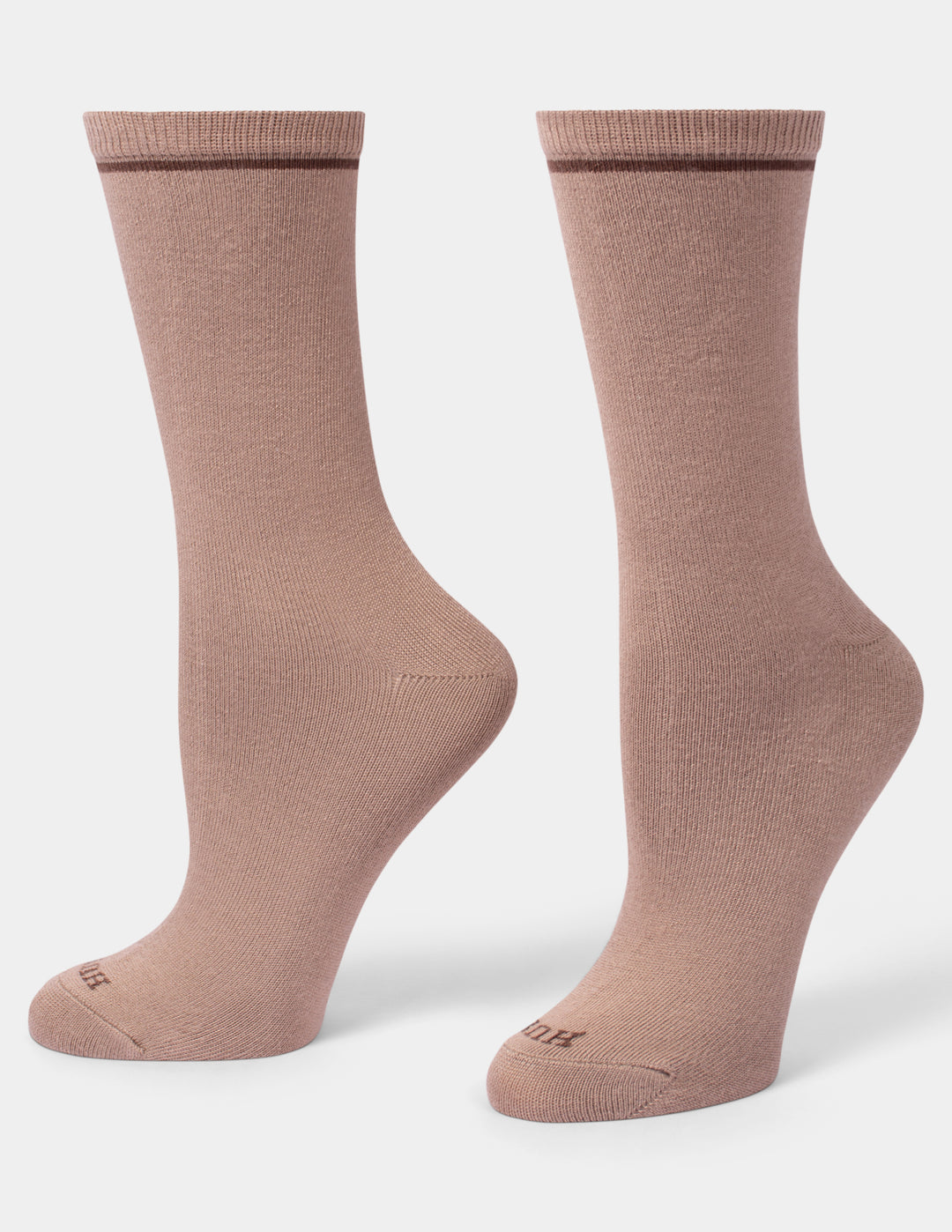 A pair of crew-length socks in a dusty rose color, displayed from the side against a clean, light gray background.