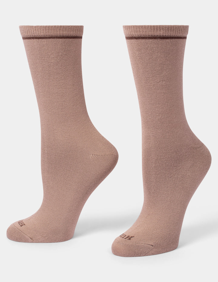 A pair of crew-length socks in a dusty rose color, displayed from the side against a clean, light gray background.