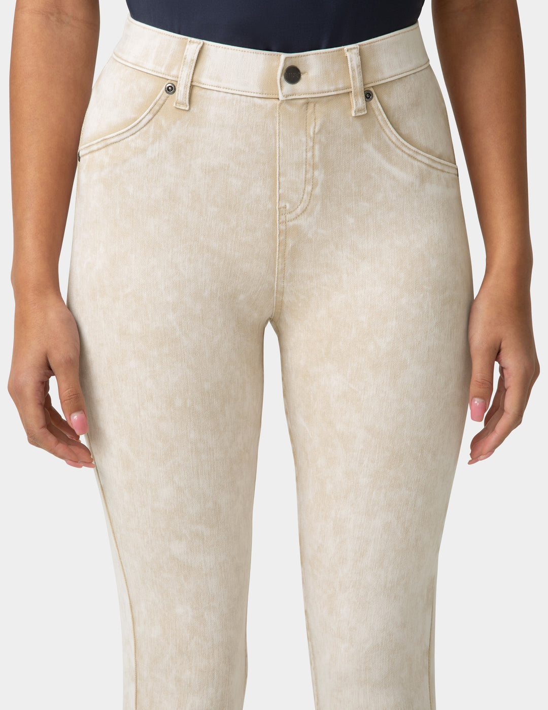 Beige jeans worn by a person on a white background