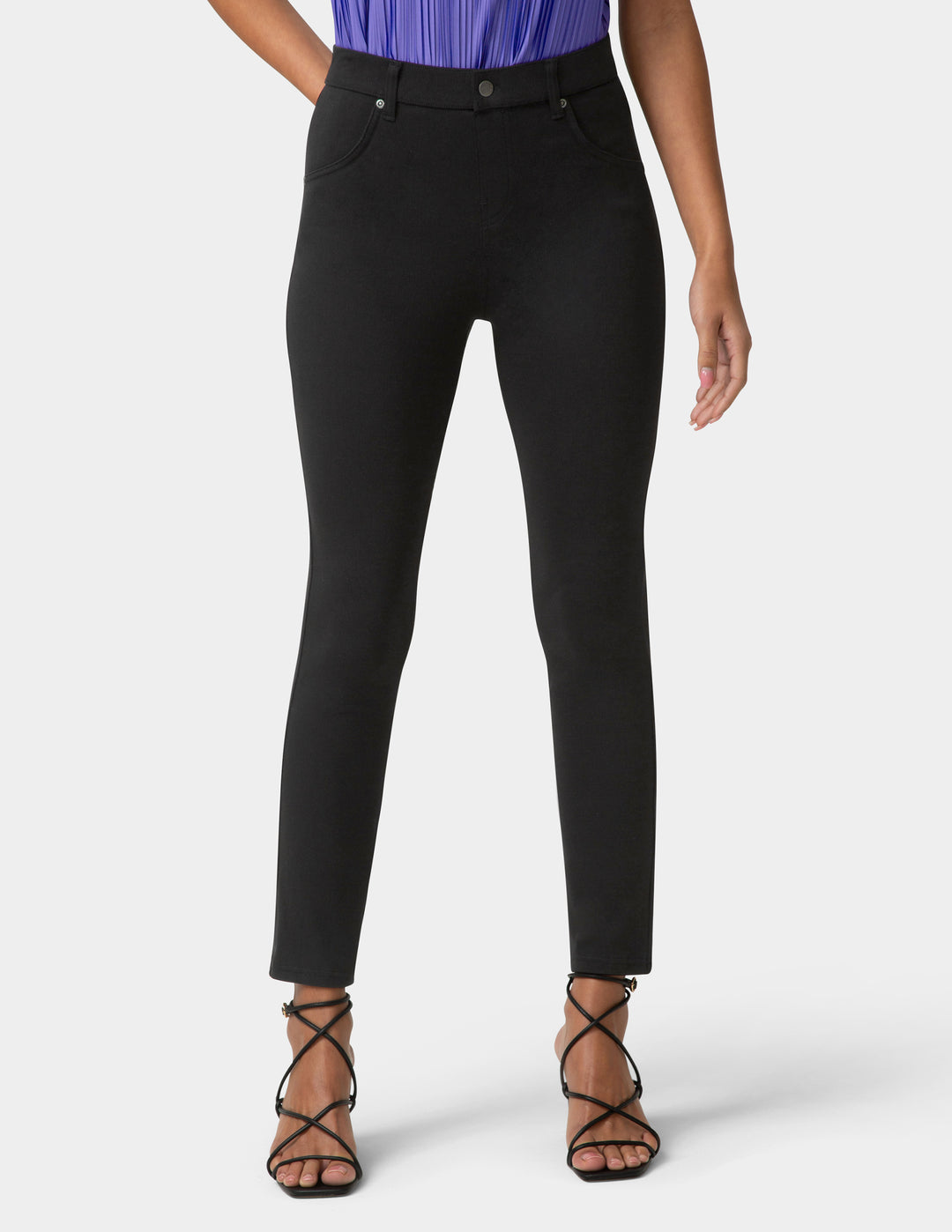 Person wearing black pants on a white background