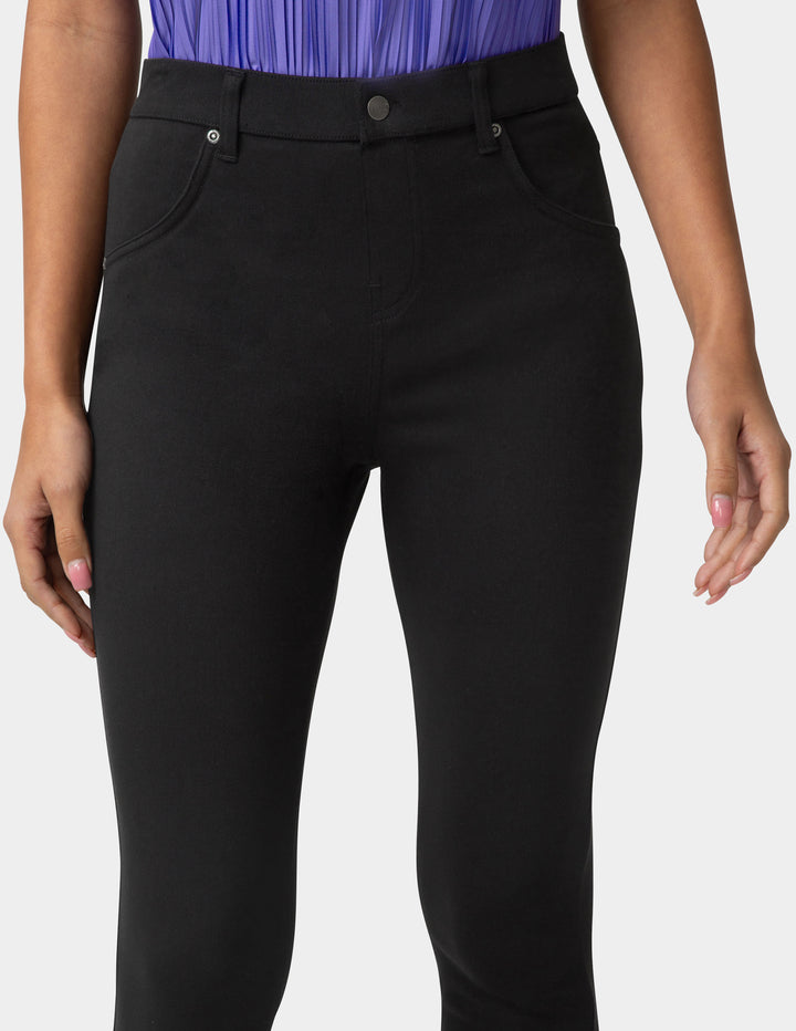 Black pants worn by a person on a white background