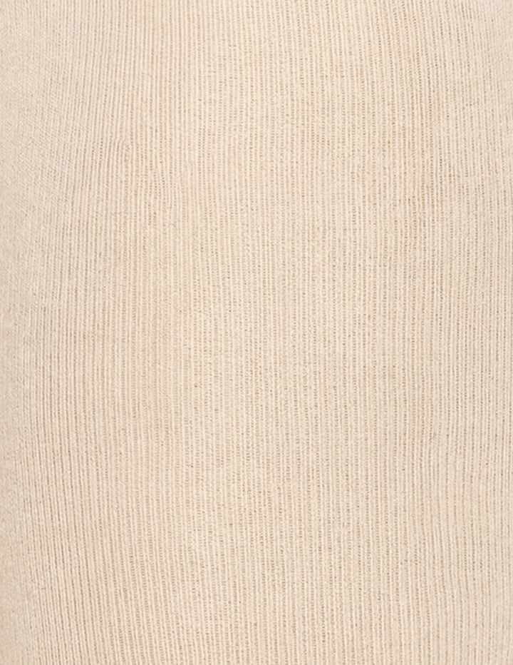Close-up of a ribbed knit fabric in a warm cream or light beige color, showing the vertical texture of the yarn.