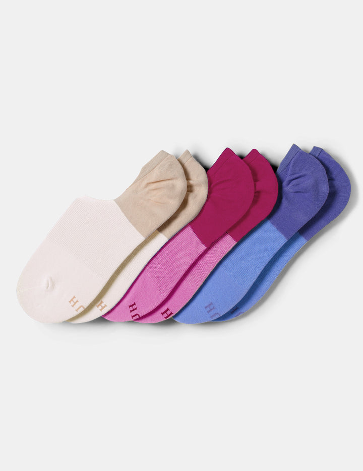 Three pairs of low-cut ankle socks arranged on a light gray background. The socks come in neutral beige, pink, and blue colorways, each with a solid block color on the top half and a heathered lower half.