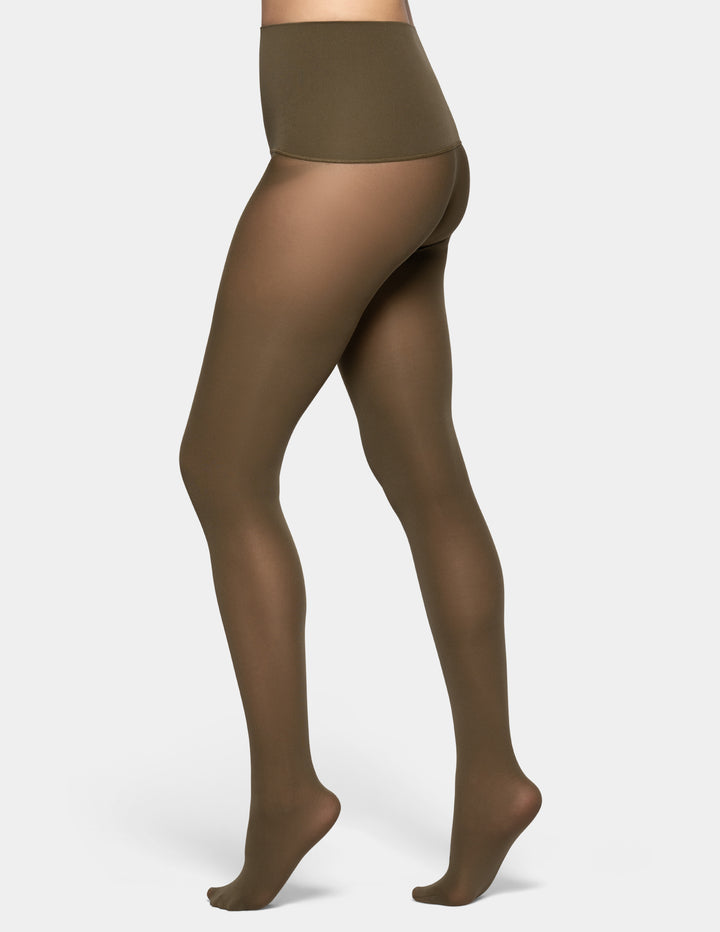 A model's lower body wearing sheer olive green tights against a light gray background.