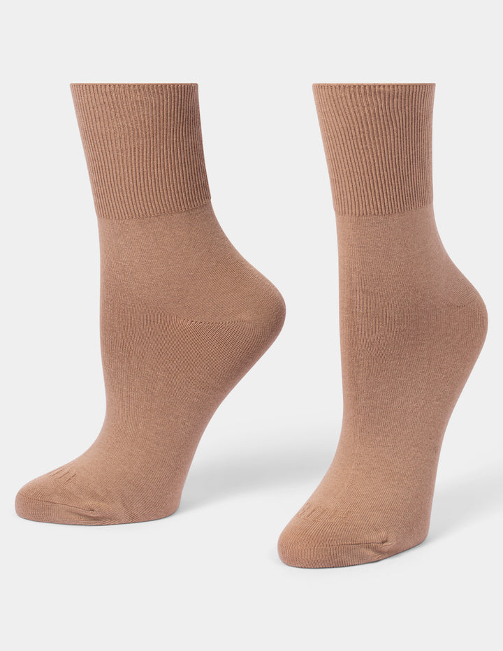 A pair of ribbed crew socks in a warm tan-brown color, displayed on foot forms against a light gray background.