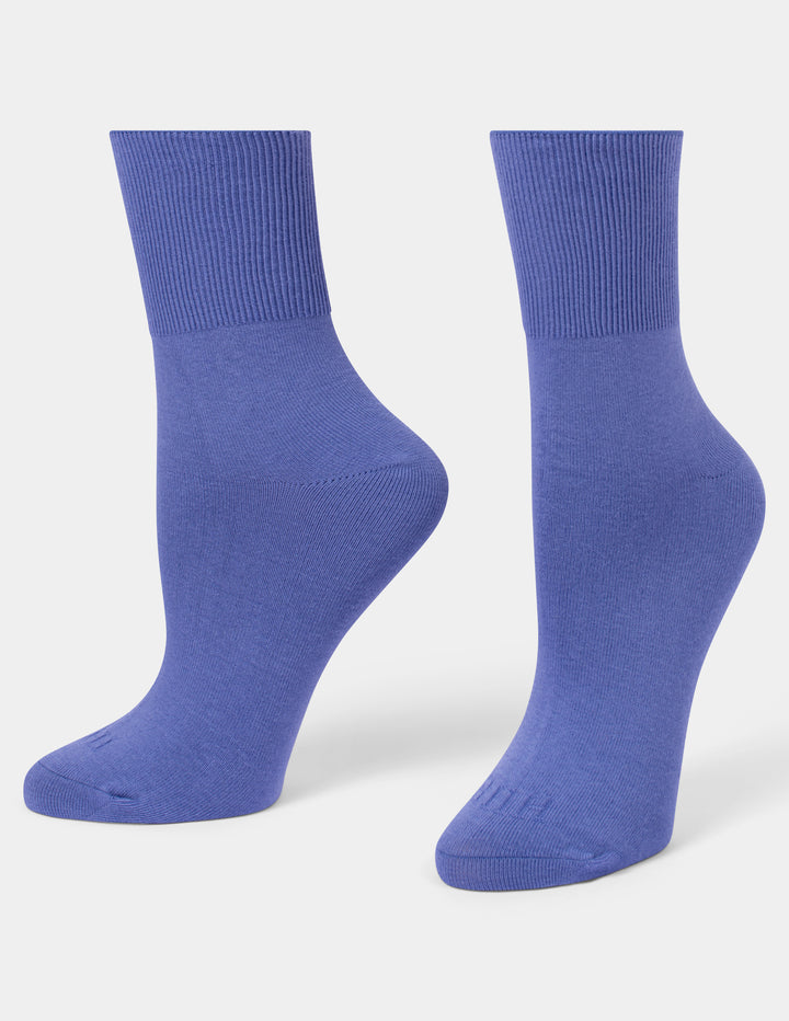 A pair of medium blue ribbed crew socks displayed on foot forms against a light gray background.