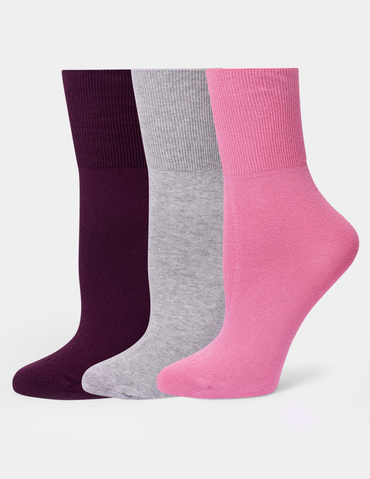 Three pairs of ribbed crew socks in dark purple, heather gray, and pink, arranged side-by-side against a light gray background.