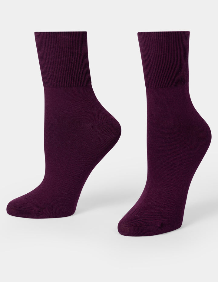 A pair of dark purple crew socks displayed on foot forms against a light gray background.
