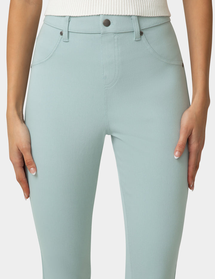 Light blue jeans worn by a person on a white background