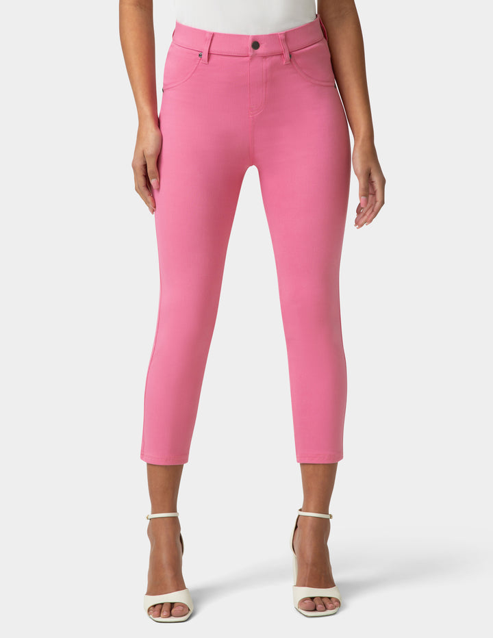 Person wearing bright pink pants on a white background