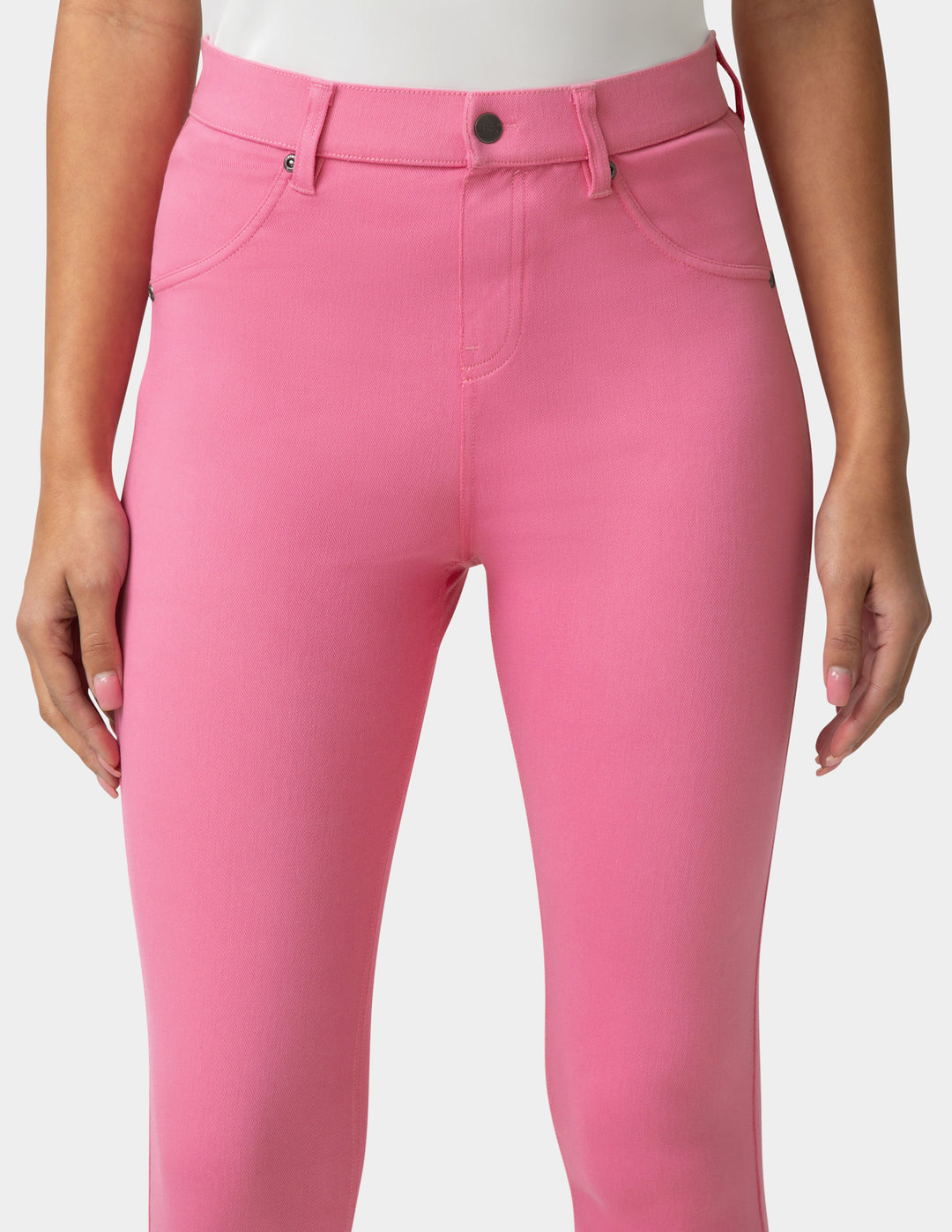 Pink pants worn by a person on a white background